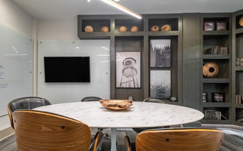 round table with chairs in clubroom with shelving