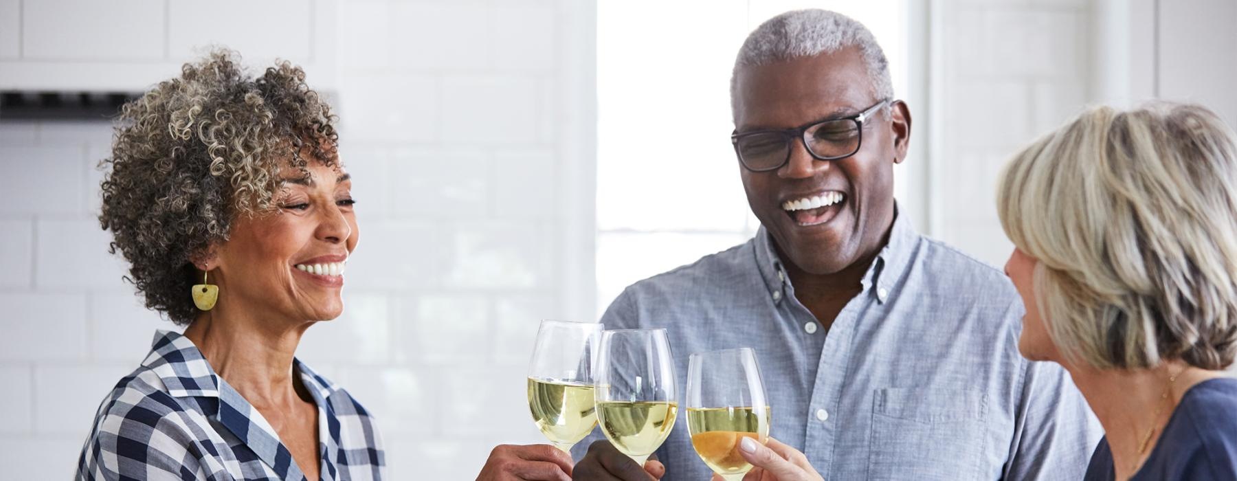 a few people toasting wine glasses